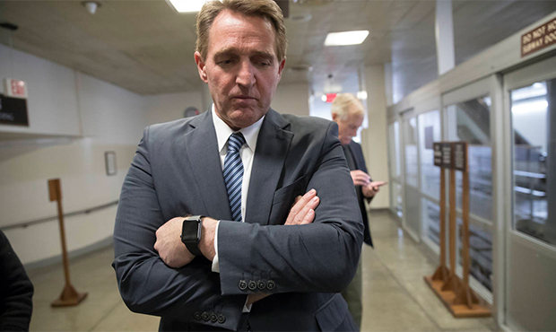 Sen. Jeff Flake, R-Ariz., waits for a subway ride back to the Capitol after he and a bipartisan gro...