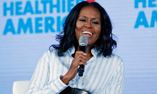 FILE - In this May 12, 2017, file photo, former first lady Michelle Obama smiles while speaking at ...