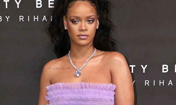 FILE - In this Sept. 19, 2017 file photo, singer Rihanna poses for photographers at the Fenty Beaut...