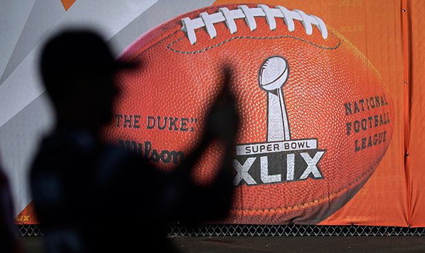 A fan takes a picture outside University of Phoenix Stadium before the NFL Super Bowl XLIX football...