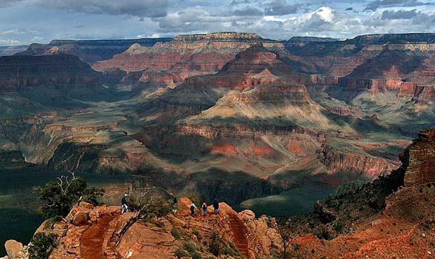 The North Rim in the background, tourists hike along the South Rim of the Grand Canyon in Grand Can...