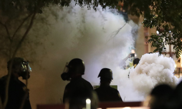 Smoke billows after Phoenix police used tear gas outside the Phoenix Convention Center, Tuesday, Au...