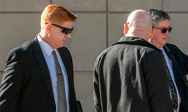FILE - In this March 21, 2018, file photo, Border Patrol agent Lonnie Swartz, left, makes his way t...