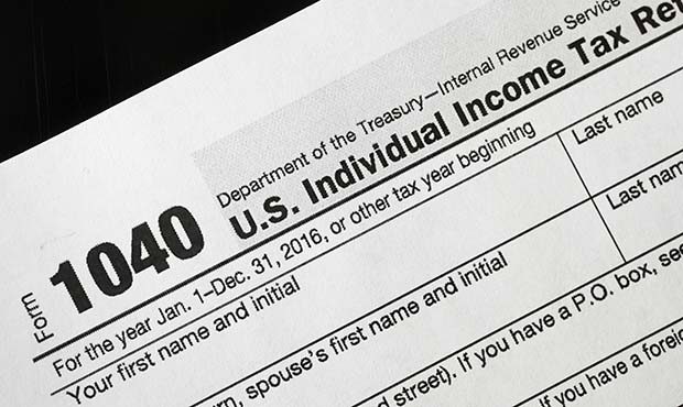 FILE - I this Jan. 10, 2017 file photo, a 1040 tax form appears on display in New York.  Last year ...