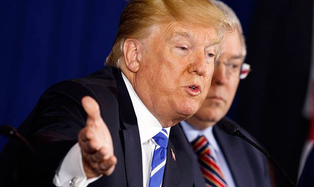 West Virginia Attorney General Patrick Morrisey, right, listens as President Donald Trump speaks du...