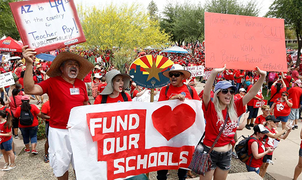 Thousands chant as they participate in a protest at the Arizona Capitol for higher teacher pay and ...