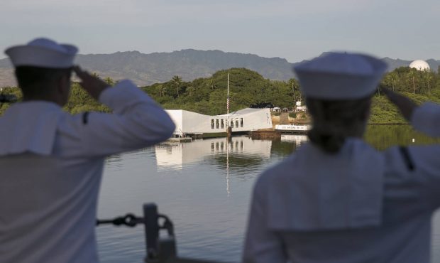 Navy sailors salute the USS Arizona memorial as the USS Halsey sails by the memorial, Wednesday, De...
