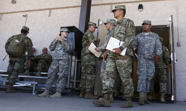 Arizona National Guard soldiers receive their reporting paperwork prior to deployment to the Mexico...