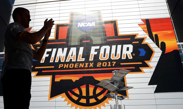 A fan takes a pictures outside of University of Phoenix Stadium before the finals of the Final Four...