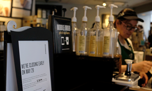 A store closing sign for May 29 is posted at a pickup counter at a Starbucks store, Friday, May 25,...