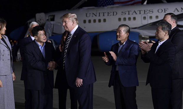 President Donald Trump, center left, shakes hands with Tony Kim, with Kim Dong Chul, third right, a...