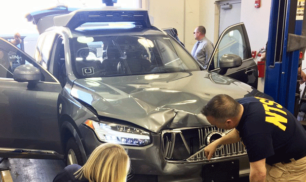 In this March 20, 2018, photo provided by the National Transportation Safety Board, investigators e...