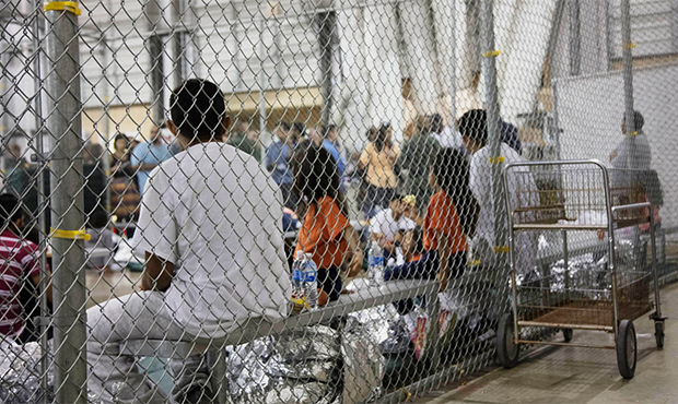 In this photo provided by U.S. Customs and Border Protection, people who've been taken into custody...