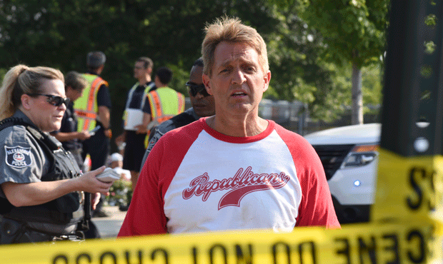 Sen. Jeff Flake, R-Ariz. walks toward media gathered at the scene of a shooting at a baseball field...
