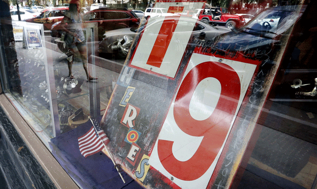 A storefront along Whiskey Row honors the 19 Granite Mountain Hotshots on the first anniversary of ...