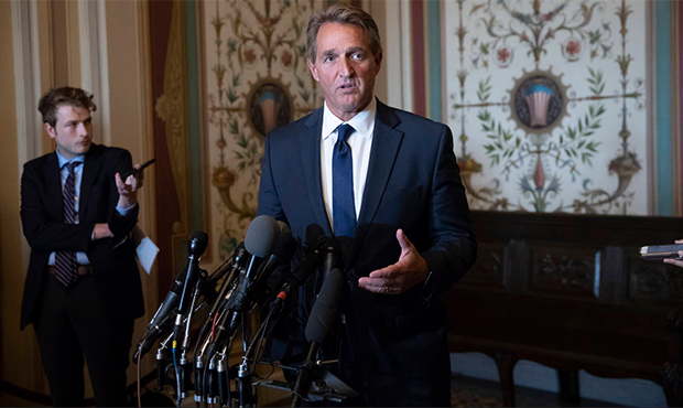 Sen. Jeff Flake, R-Ariz., a member of the Senate Foreign Relations Committee speaks with reporters ...