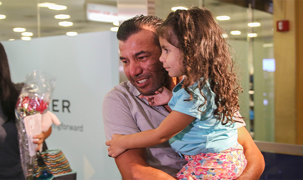 Migue Calix holds daughter, Alisha Calix Santos, 3, after she arrived in Washington with her mother...