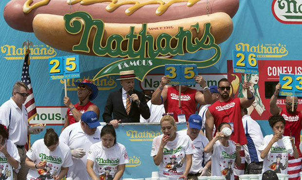The competitors eat hot dogs during the women's competition of the Nathan's Famous Fourth of July h...
