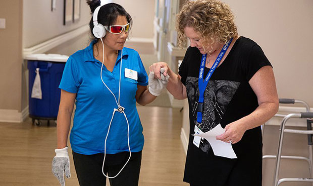 Debi Elder (right), a community liason with Haven Behavorial Hospital of Phoenix, escorts Vilma Bos...