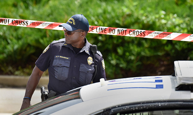 Police investigate the scene of a multiple shooting Sunday, Aug. 26, 2018, at the Jacksonville Land...