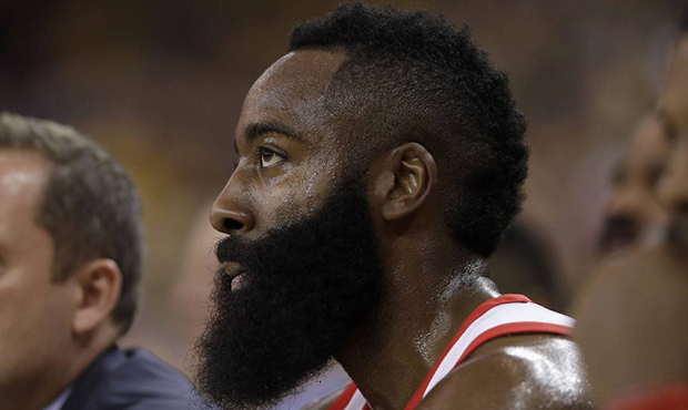 Houston Rockets guard James Harden sits on the bench during the first half of Game 4 of the NBA bas...