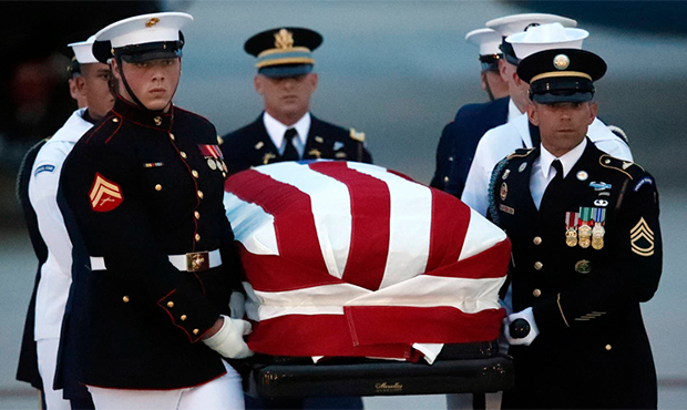 The flag-draped casket of Sen. John McCain, R-Ariz., is carried by an Armed Forces body bearer team...