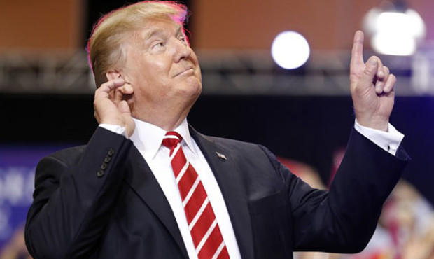 President Donald Trump reacts to the song as he arrives at a rally at the Phoenix Convention Center...