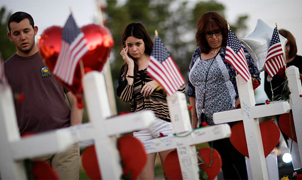 FILE - In this Oct. 6, 2017, file photo, people visit a makeshift memorial for victims of a mass sh...