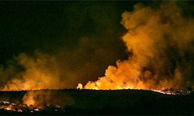 In this Monday, April 24, 2017 photo, the Sawmill Fire burns along the ridge line east of Arizona H...