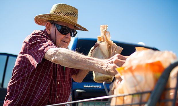 Edgar Joseph loads plastic grocery bags into his car outside of a Fry's Food & Drug Store in Ph...