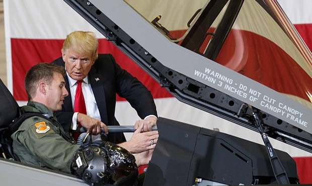 President Donald Trump talks to a pilot in the cockpit of an F-35 aircraft during a Defense Capabil...