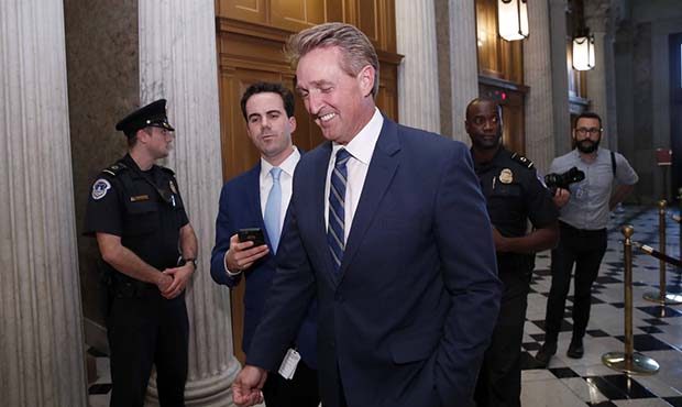 Sen. Jeff Flake, R-Ariz., heads to the Senate floor for the confirmation vote of Supreme Court nomi...