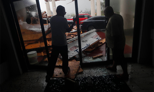 Hotel employees look at a canopy that just collapsed, as Hurricane Michael passes through in Panama...