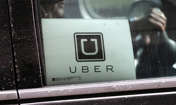 FILE - In this March 15, 2017, file photo, a Uber car drives through LaGuardia Airport in New York....