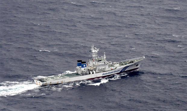 In this aerial photo, Japan's Coast Guard ship is seen at sea during a search and rescue operation ...