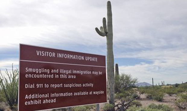 FILE - In this October 30, 2014, file photo, a sign warns visitors of smuggling and illegal immigra...