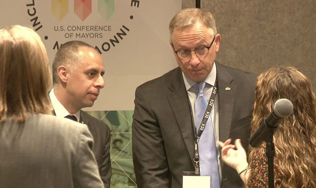 Mesa Mayor John Giles, right, and Providence, Rhode Island, Mayor Jorge Elorza talk to audience mem...