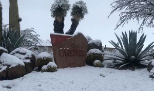 Snow lands, really sticks in far Phoenix area during record rainy day