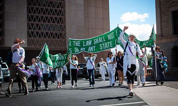 Chanting marchers arrive at the Capitol after completing the final miles in their 38 mile walk to s...