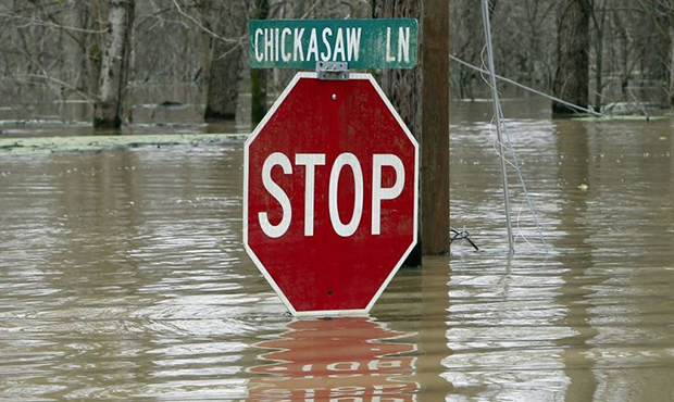 Yazoo River waters almost submerges this stop sign in the Chickasaw subdivision of Vicksburg, Miss....