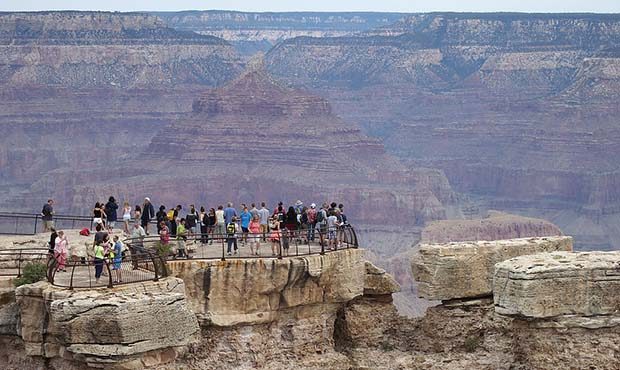 GRAND CANYON NATIONAL PARK, AR - JULY 14:  Visitors stand at the Grand Canyon South Rim on July 14,...