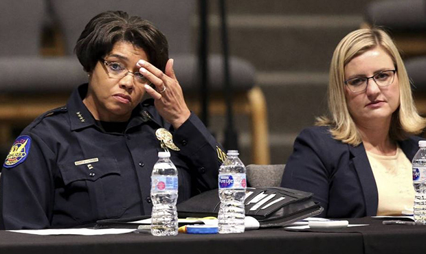 Phoenix Police Chief Jeri Williams, left, and Mayor Kate Gallego, right, listen to a speaker at a c...
