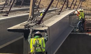 Crews place final bridge girder for new South Mountain Freeway