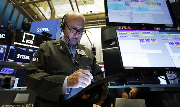 Trader Andrew Silverman works on the floor of the New York Stock Exchange, Tuesday, Aug. 6, 2019. S...
