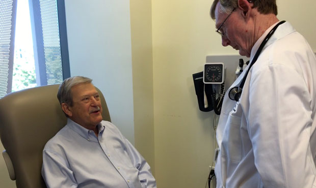 Mike Kucharo, left, of Phoenix, who was diagnosed with breast cancer in 2014, talks to Dr. Albert W...