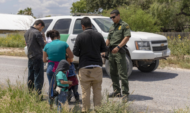 An immigrants family turn itself in to a Border Patrol agent after crossing the Rio Grande in June ...