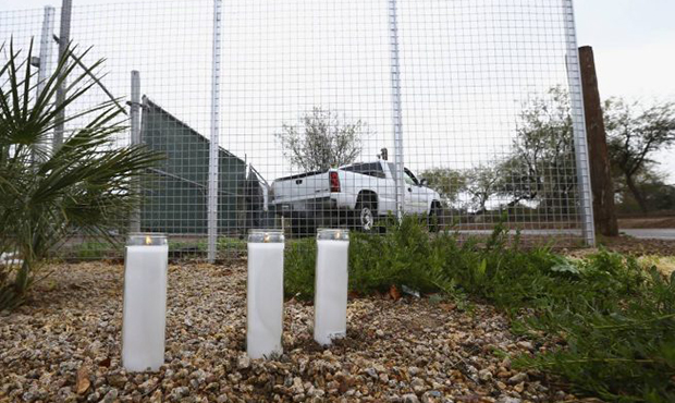 A makeshift memorial is set up near a home where a Phoenix woman was arrested on suspicion of killi...