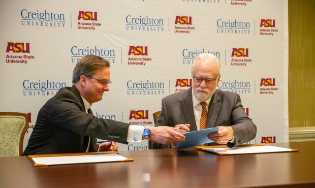 Left: Father Daniel Hendrickson, President of Creighton University. Right: Mark Searle, executive v...