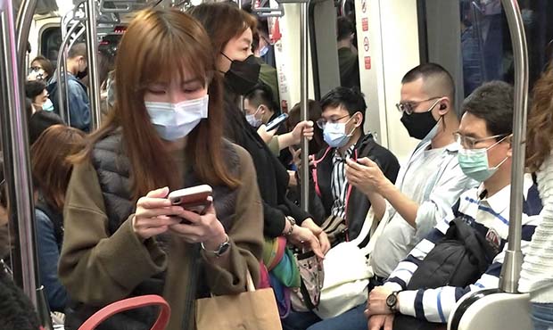 People wear face masks to protect against the spread of the coronavirus on MRT in Taipei, Taiwan, S...