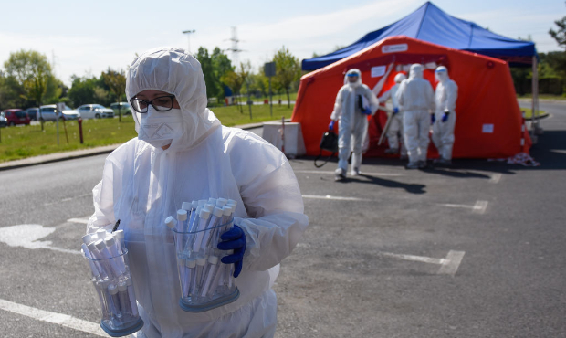 RYBNIK, POLAND - MAY 08: A health worker wears a protective suit, gloves, mask and a face shield as...